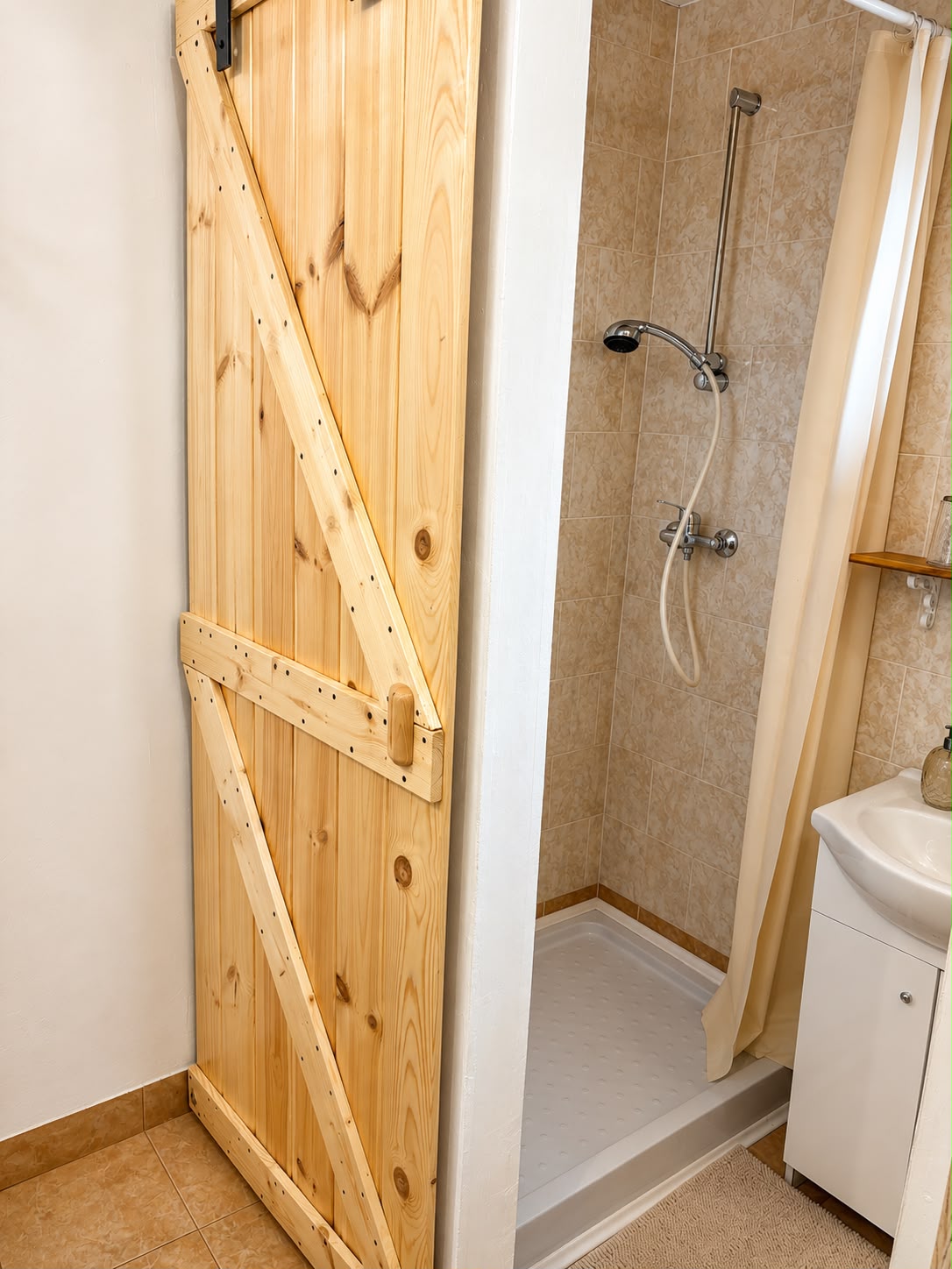 Bathroom with wooden barn door shower